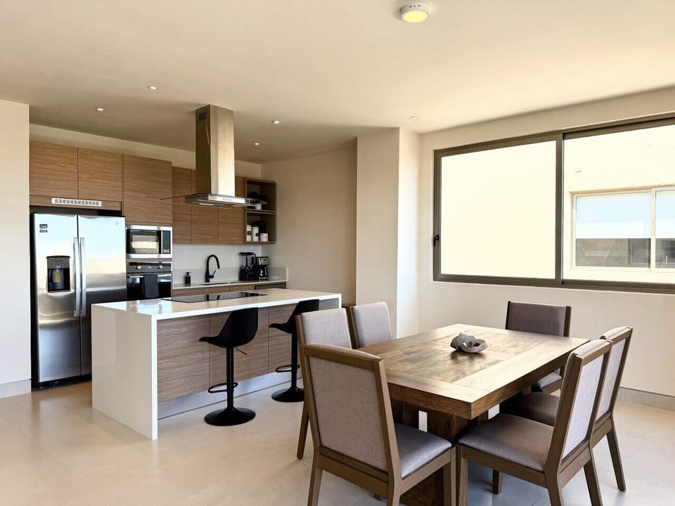 Kitchen with modern appliances and adjacent dining area.