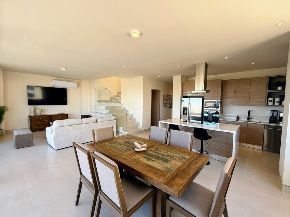 Open-concept living area with dining space and access to kitchen.