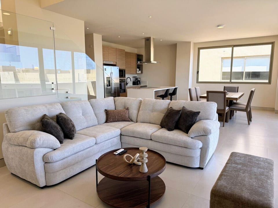 Open living area with sectional sofa and dining space
