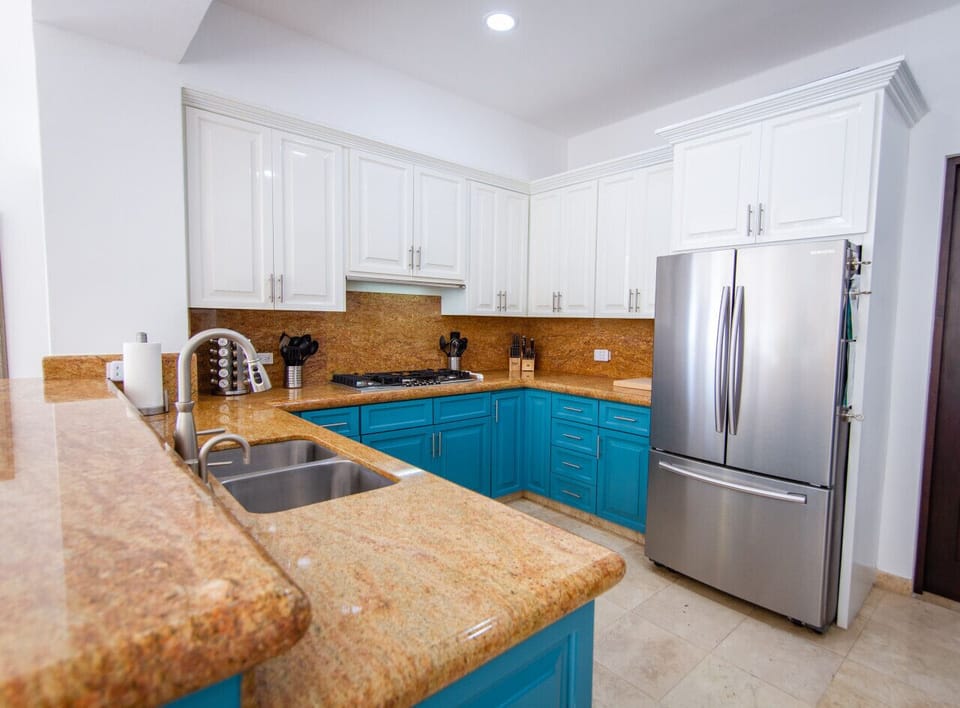 Fully equipped modern kitchen with ample counter space and stylish cabinets.