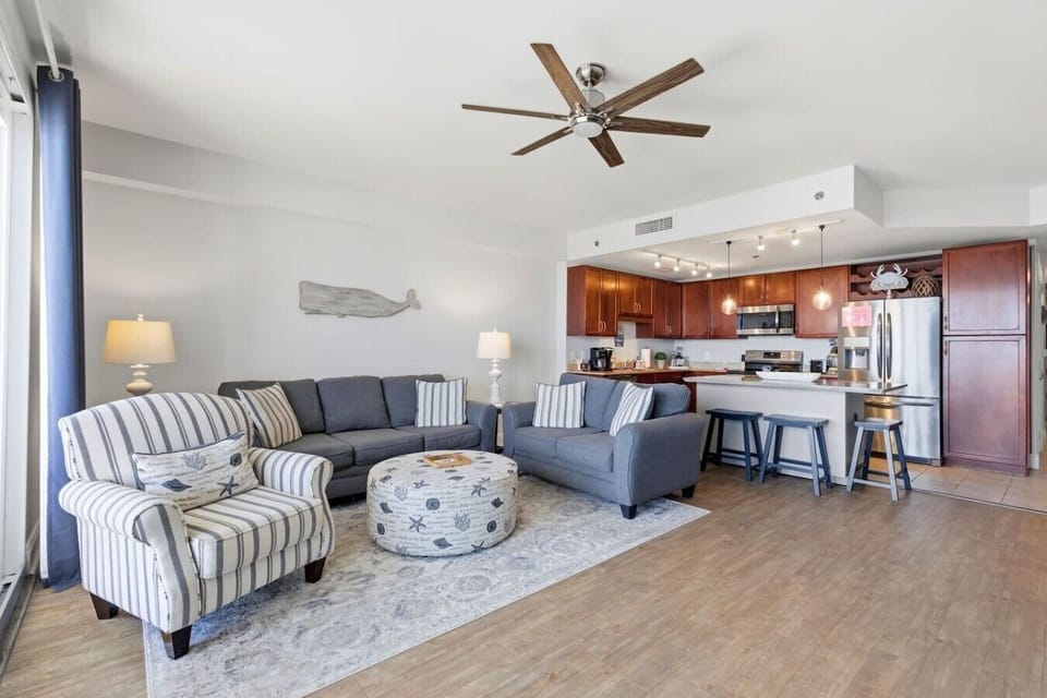 Spacious living room with plenty of seating and beautiful Gulf views from the oversized balcony doors.