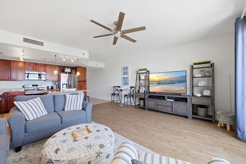 Spacious living room with plenty of seating and beautiful Gulf views from the oversized balcony doors.