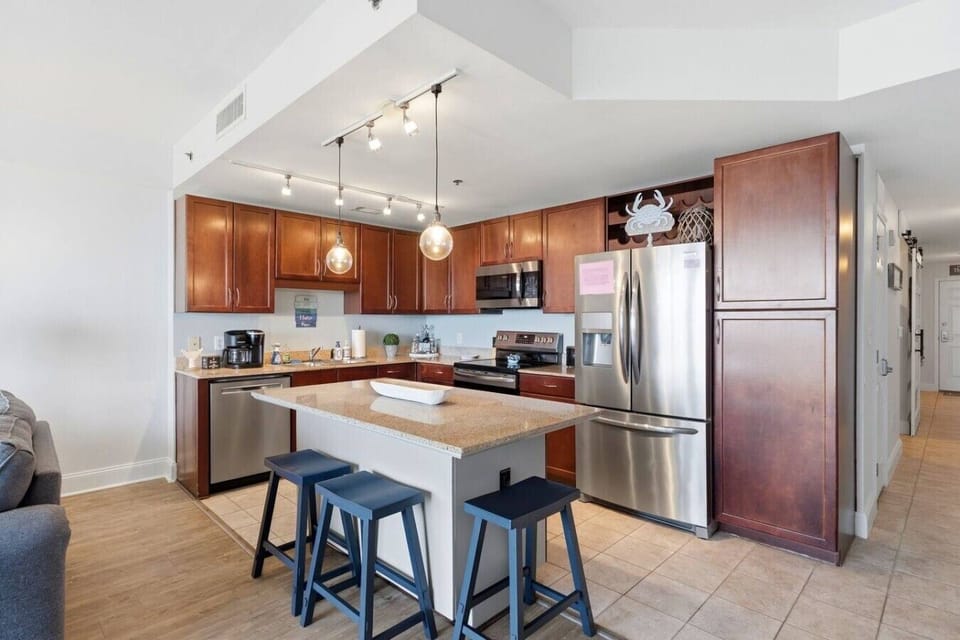 Fully equipped kitchen with stainless steel appliances and island seating for casual dining.
