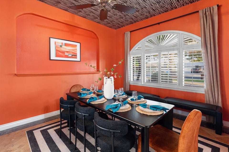 Vibrant walls, patterned ceilings, and seating for the whole group — dining done right.