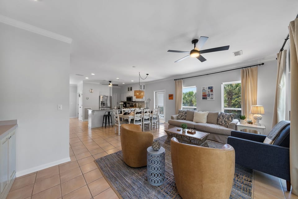 The open living room flows seamlessly offers direct access to 2 patios