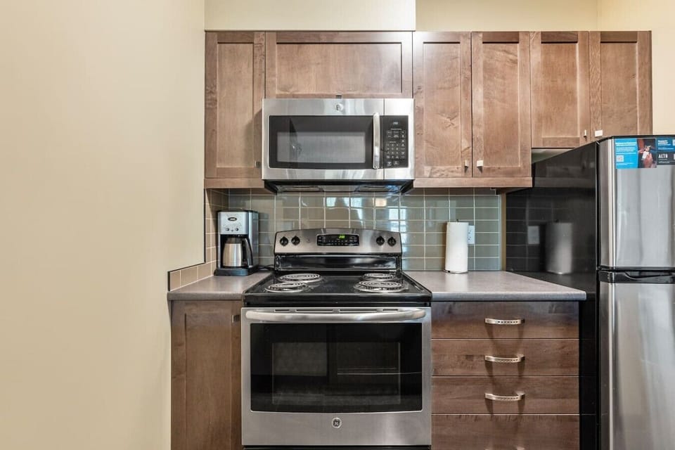 Full kitchen with a drip coffee machine, blender & crockpot.