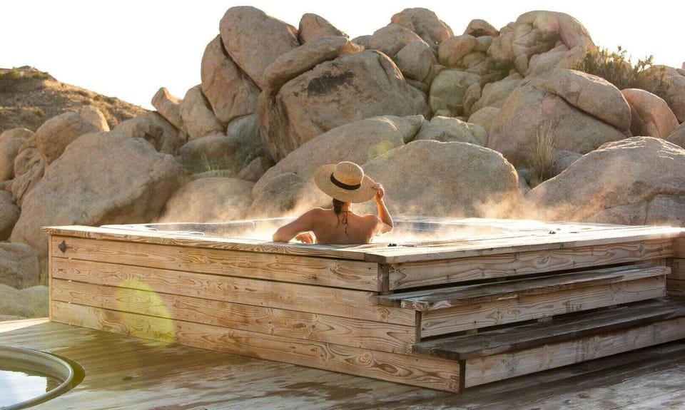 Soak in the hot tub amongst the boulders.