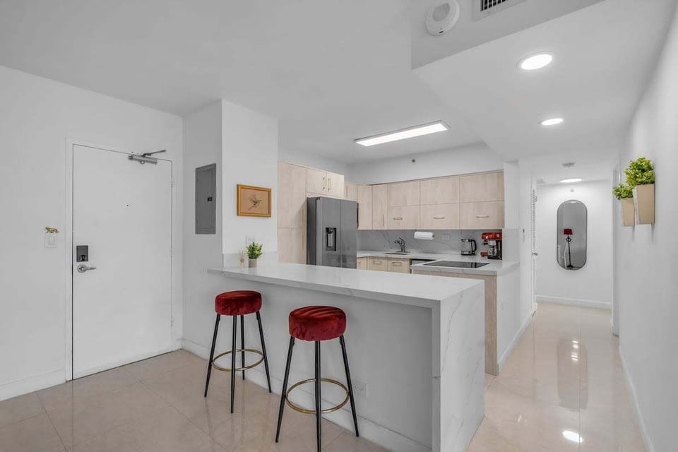Sleek open kitchen with modern finishes, breakfast bar, and everything you need for a comfortable stay