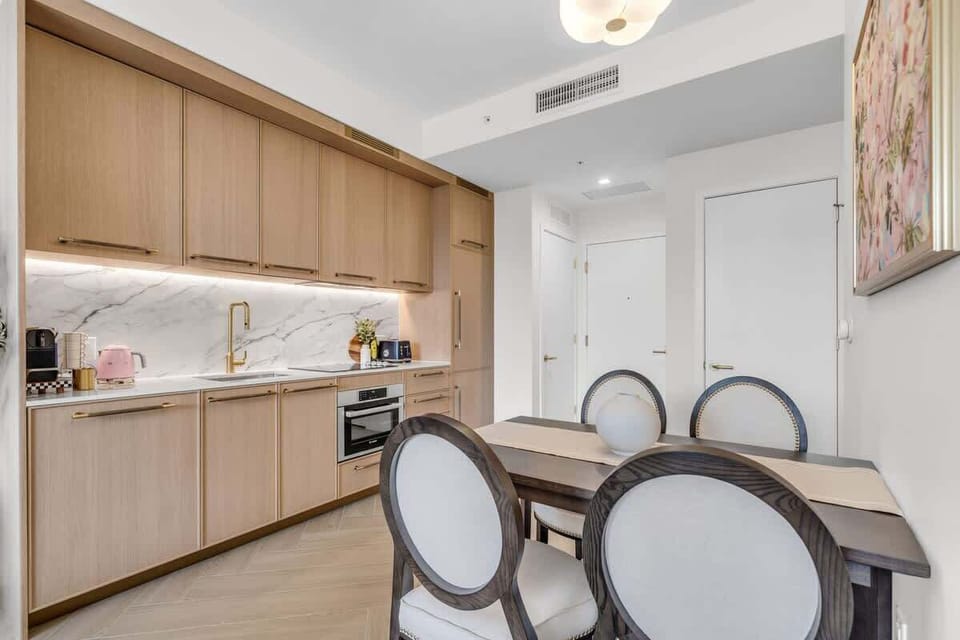 Elegant dining area with designer chairs and warm wood finishes — a sophisticated space to enjoy your meals together