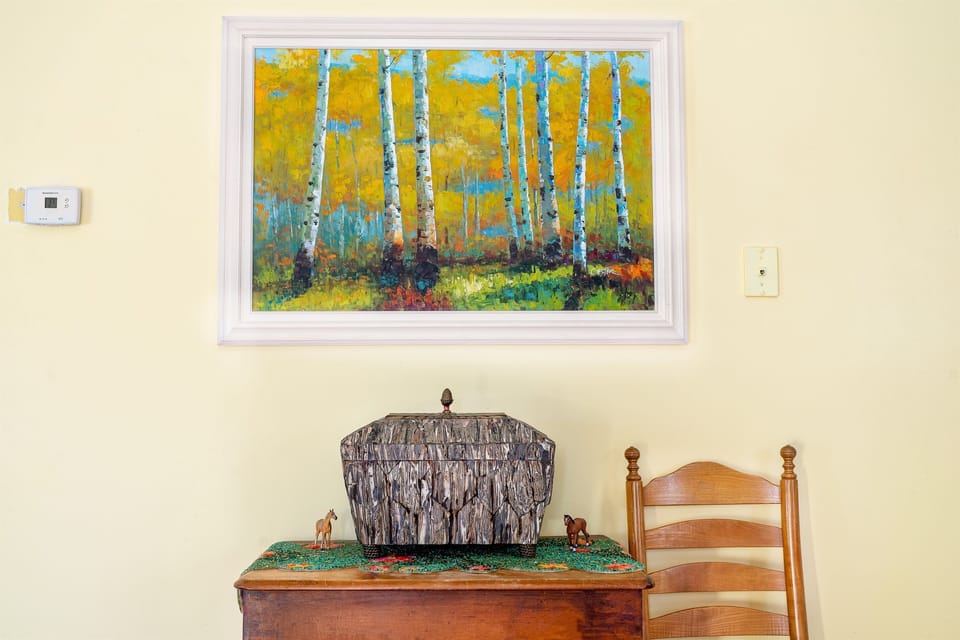 Thoughtful local touches throughout Seven Peaks Ridge create a warm, inviting atmosphere. This decorative nook between the dining room and foyer showcases the estate's curated charm, making your Southwest Harbor retreat feel like a true Maine home.