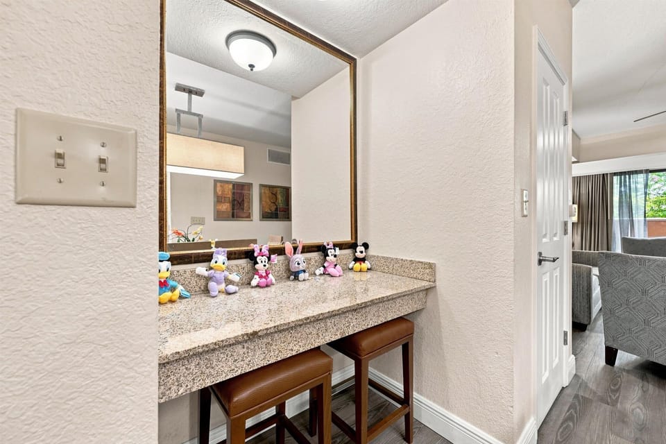 Breakfast bar with three stools beside the kitchen and dining area