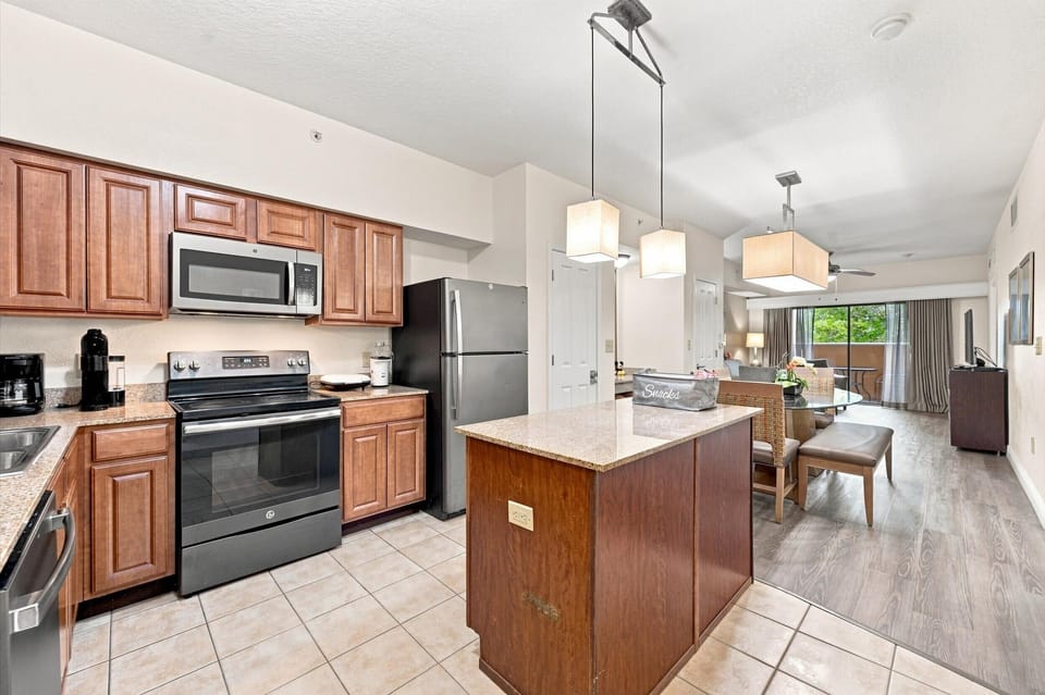 Full kitchen with granite island and stainless steel appliances