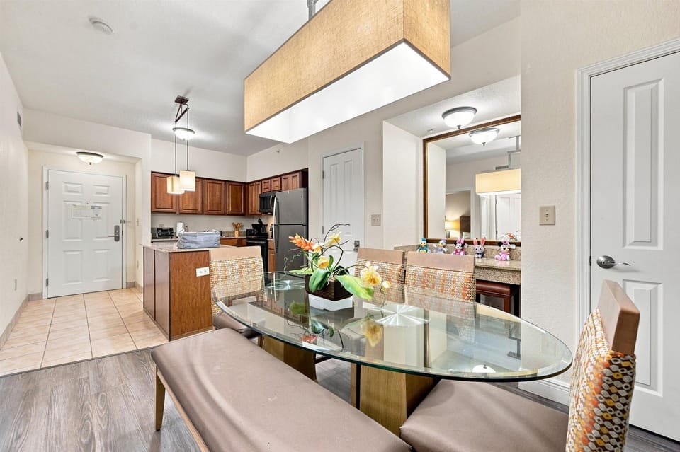 Glass dining table sits beside the fully equipped kitchen