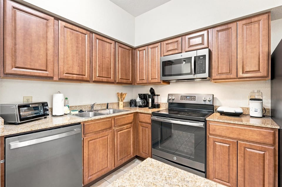 Full kitchen with stove, microwave, dishwasher, and refrigerator