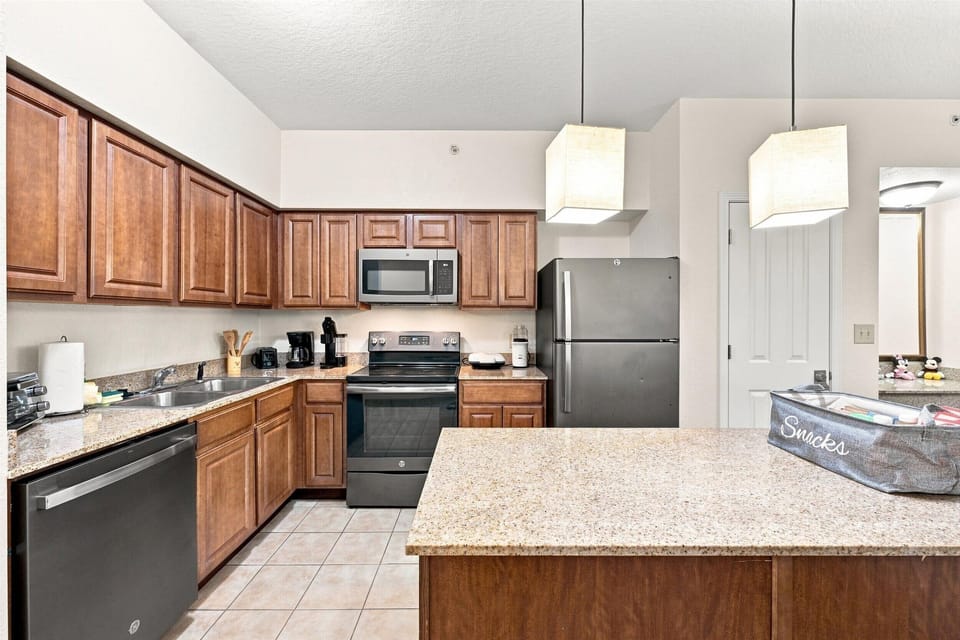 Full kitchen with dishwasher, stove, microwave, and refrigerator