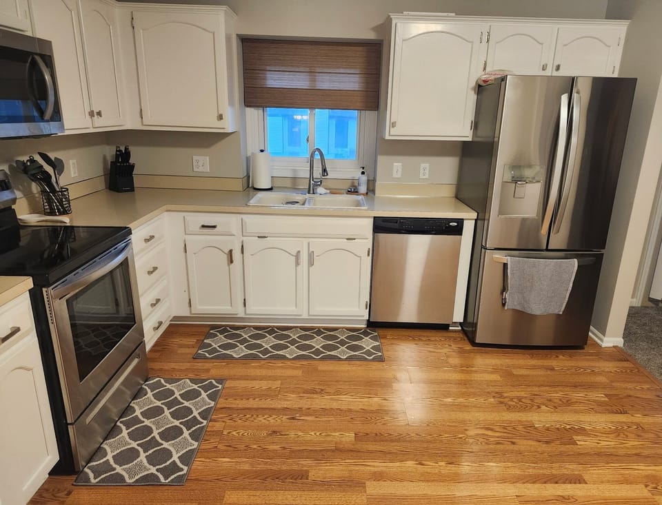 kitchen with microwave, oven, refrigerator, stovetop