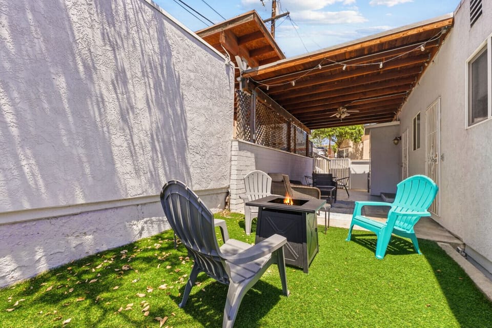 Your own peaceful backyard oasis awaits, complete with lounge chairs and a cozy fire feature.
