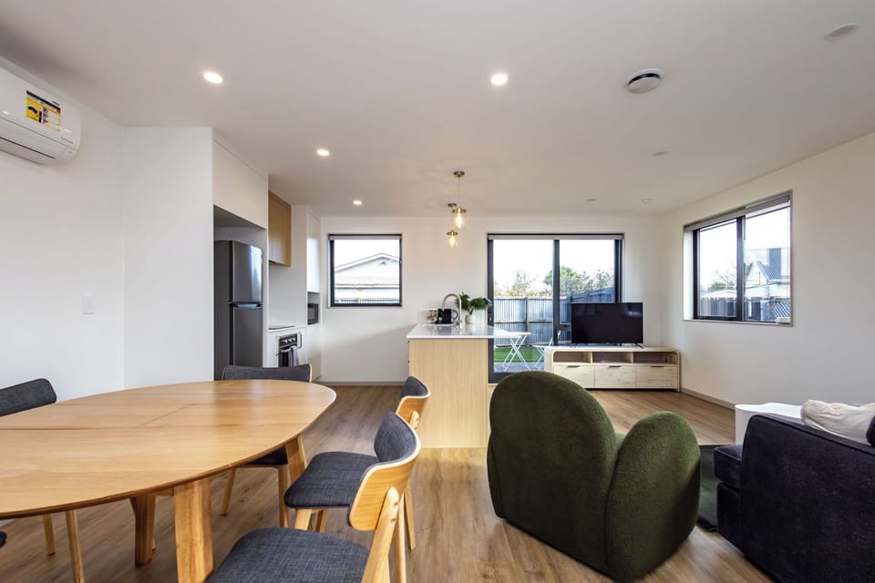 Modern open-plan design connecting living room, kitchen, and dining area