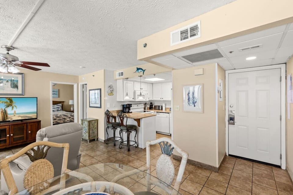 Bright coastal entryway with an open-concept layout and convenient breakfast bar seating.