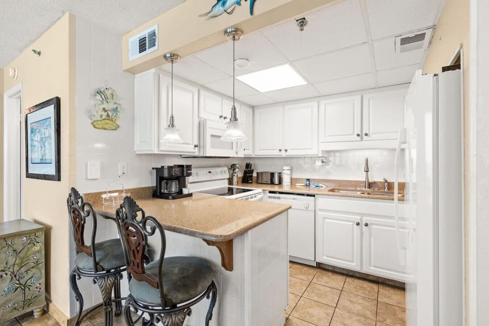 Updated coastal kitchen with modern appliances and everything needed for preparing meals at the beach.