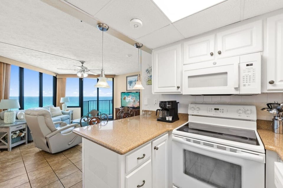 Spacious kitchen overlooking the living room and Gulf views for an inviting open layout.