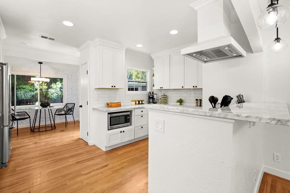 Fully equipped kitchen with modern appliances, stocked coffee bar, ample prep space, and everything needed to cook at home.