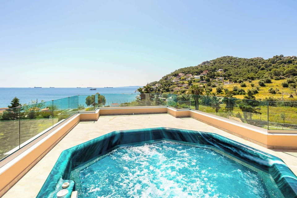 The rooftop jacuzzi looks across the coastline and surrounding hills, creating a quiet space to unwind after the beach.