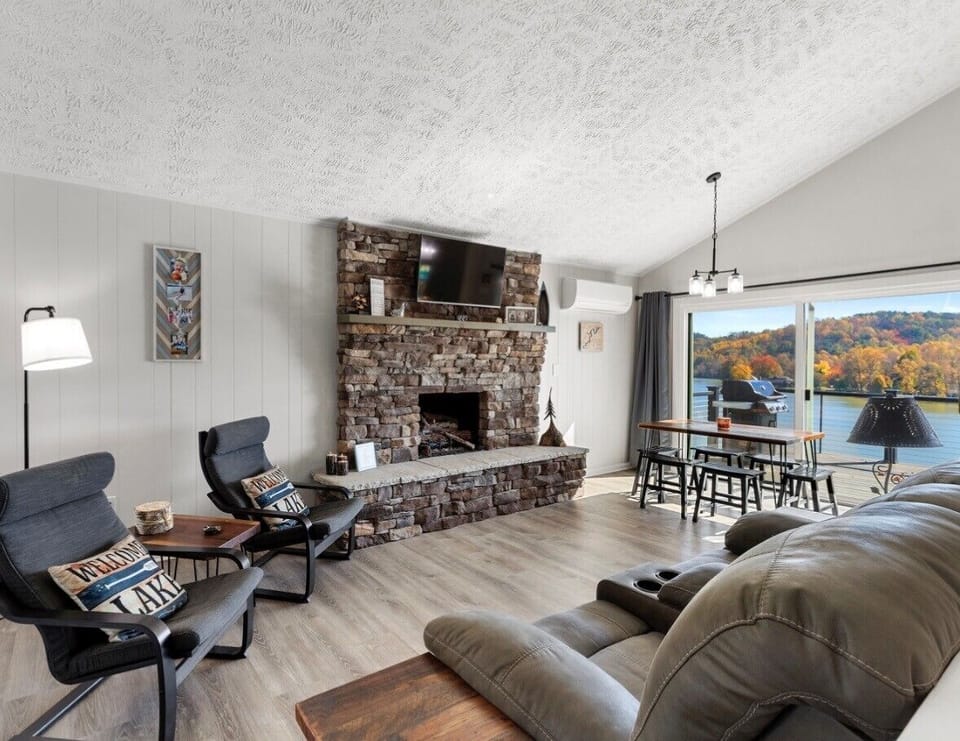 Comfortable living room with fireplace and lake views.