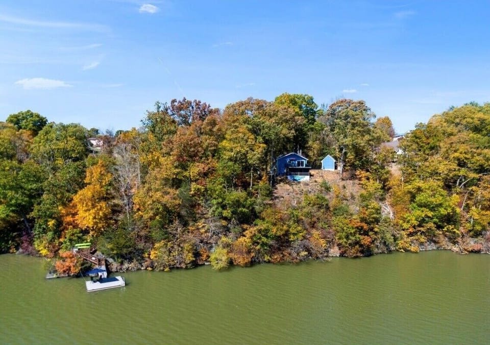 Private lakeside setting surrounded by trees.