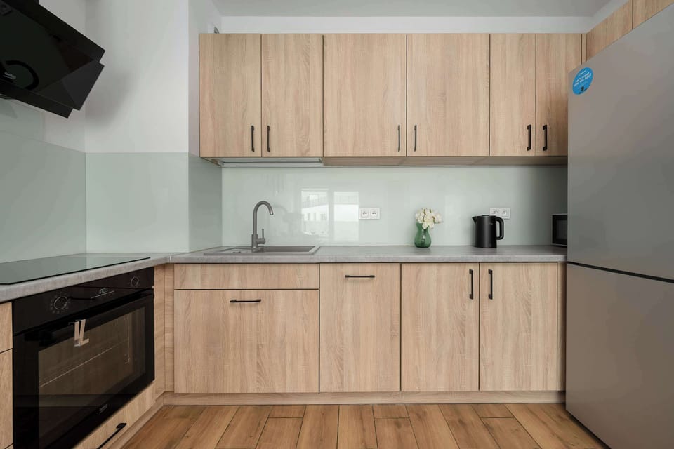 The sleek design of the kitchenette blending seamlessly with the living area.