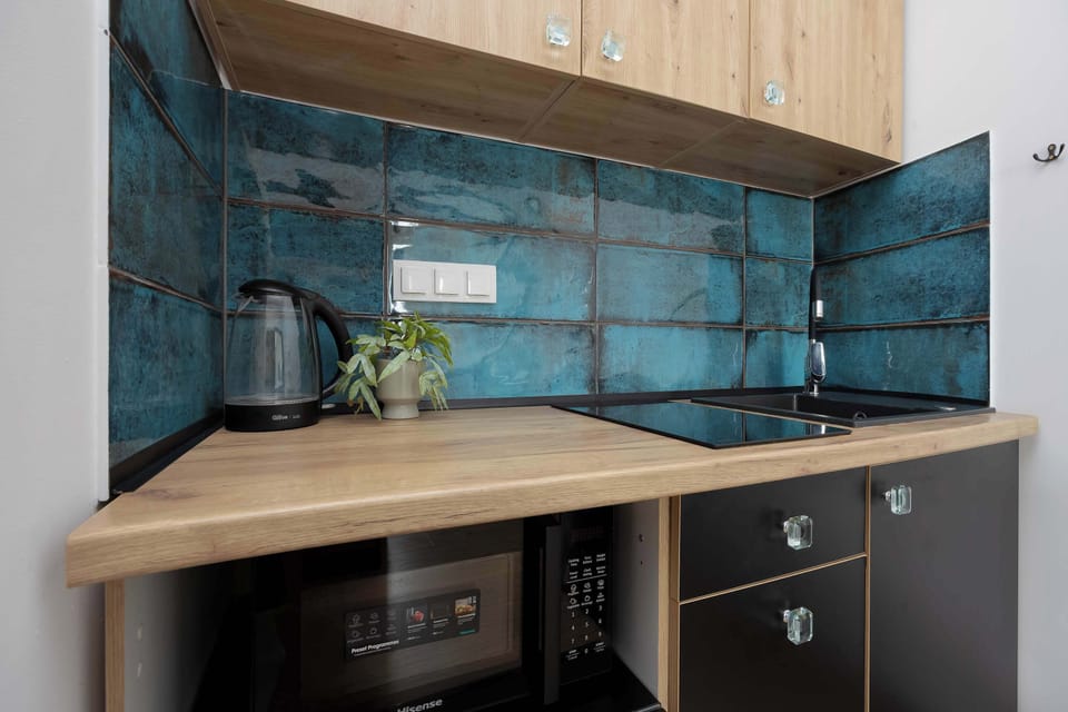 Contemporary kitchen with wooden countertop and glossy tiles