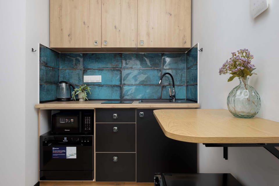 Kitchen detail with modern tile backsplash and decorative vase