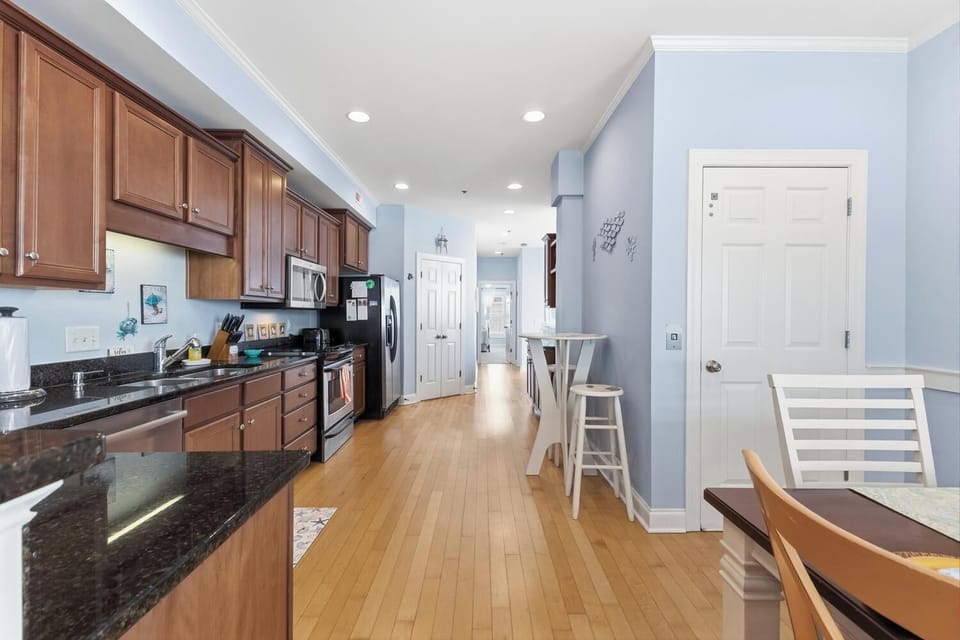 Step into your spacious, well-equipped kitchen featuring elegant granite countertops, rich wood cabinetry, and stainless steel appliances. The bright, open layout flows seamlessly into your dining area, perfect for gathering and creating memories.