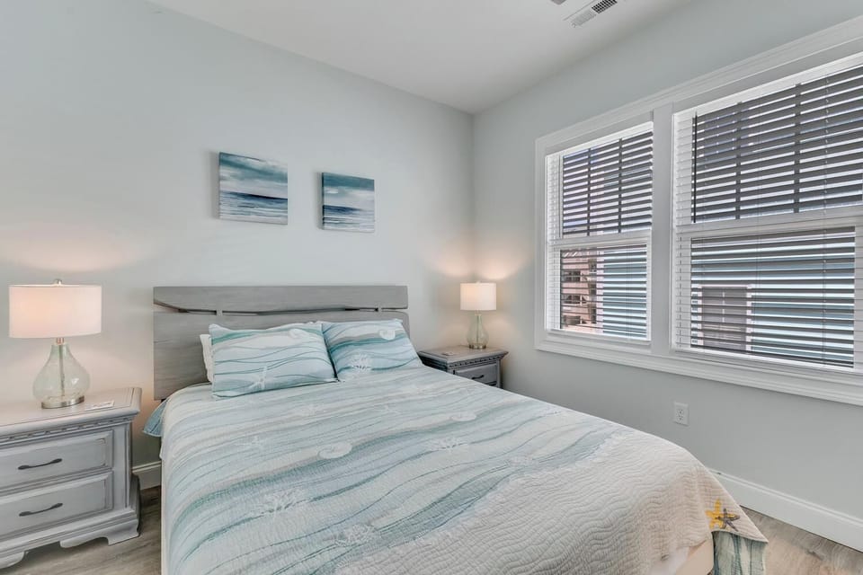 Drift off to sleep in your serene coastal-themed bedroom, where soft blues and calming ocean art help you unwind, and bright natural light greets you each morning.