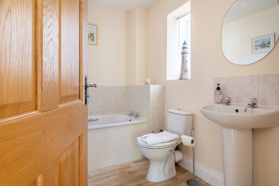 Ground floor: Family bathroom with a bath, wash basin and WC