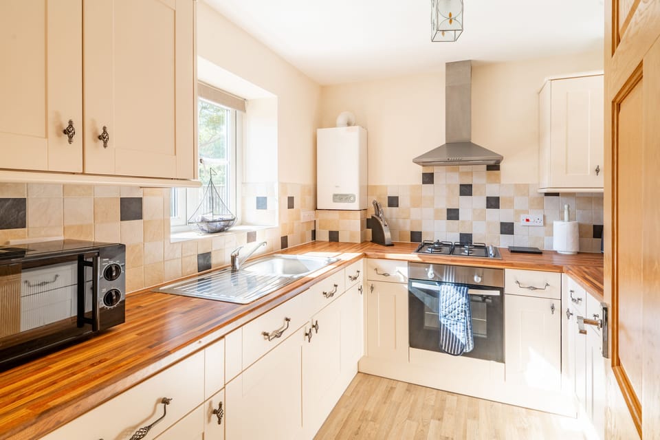 Ground floor: Kitchen with electric oven and gas hob, microwave, dishwasher and fridge-freezer