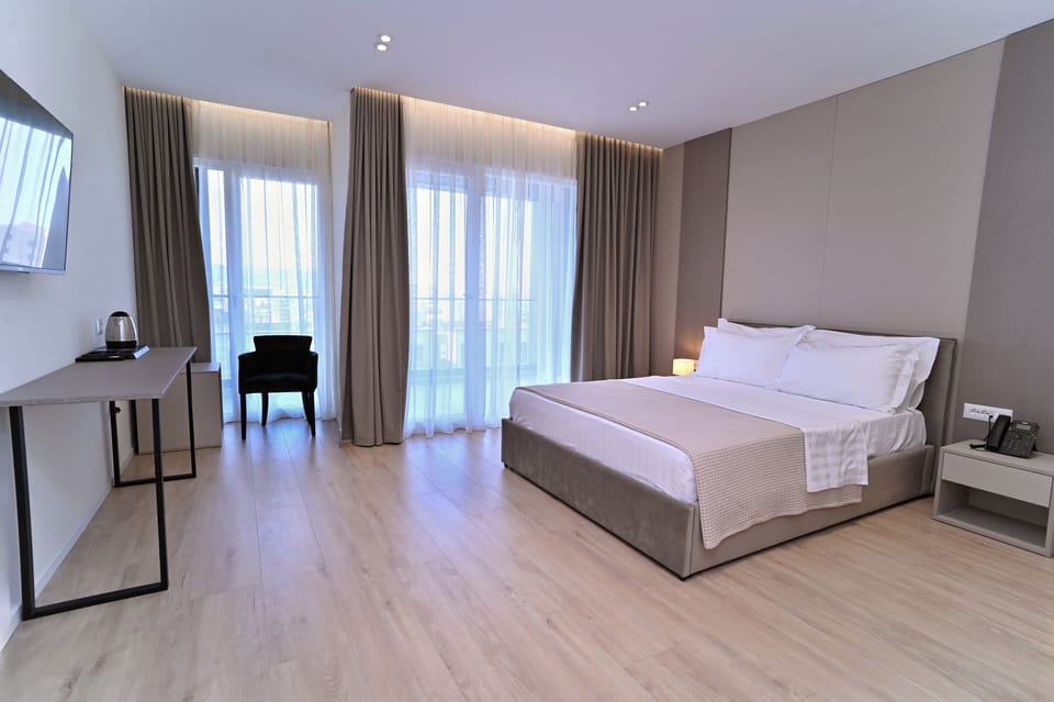 Superior Double Room, Balcony | In-room safe, desk, laptop workspace, blackout drapes