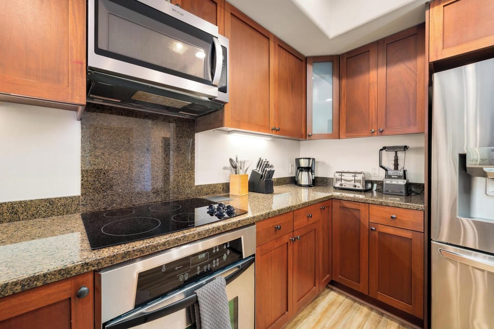 Your fully equipped kitchen features warm cherry cabinets, granite counters, stainless appliances, and everything you need to prepare delicious home-cooked meals during your stay.