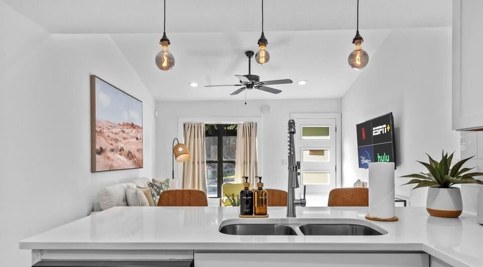 Open sightlines from the kitchen peninsula keep the cook connected to the whole group.