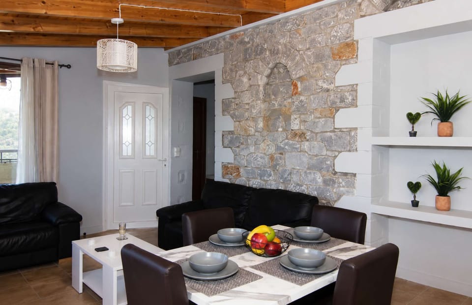 Modern open-plan living space with rustic stone details.