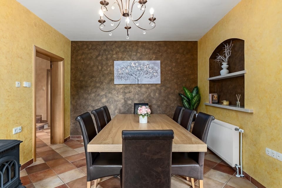 Cozy interior with a dining table by the fireplace for a warm atmosphere.
