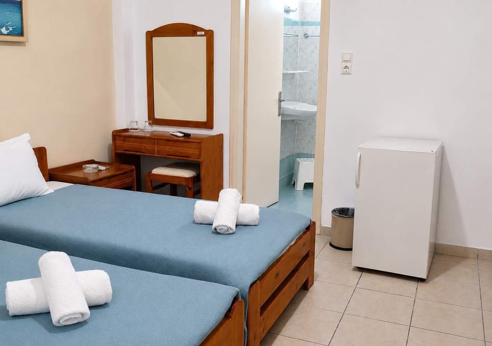 Cozy Bedroom equipped with a TV, mini-fridge, modern air-conditioning and an en-suite bathroom