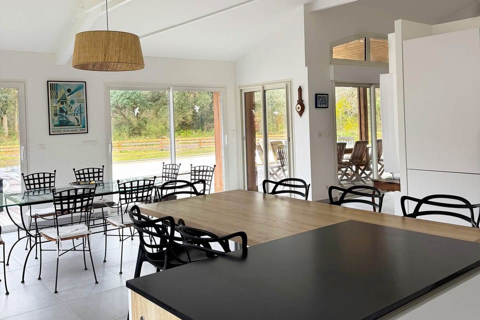 Open-plan living and dining, high ceiling, mezzanine staircase visible, bright:<br>The generous open-plan layout with mezzanine adds volume and flexibility — this villa genuinely feels as spacious as it looks.