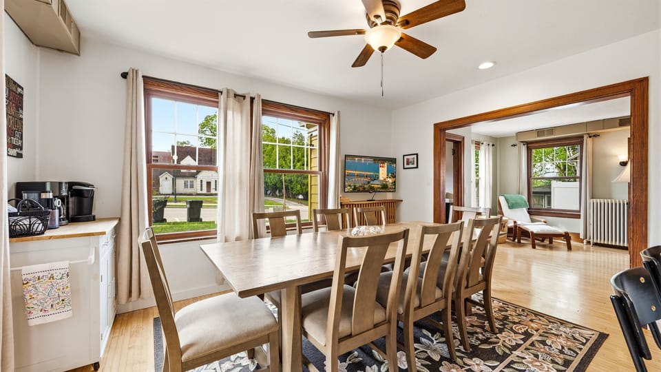 Spacious dining area featuring a table that comfortably seats 8, perfect for shared meals and gatherings.