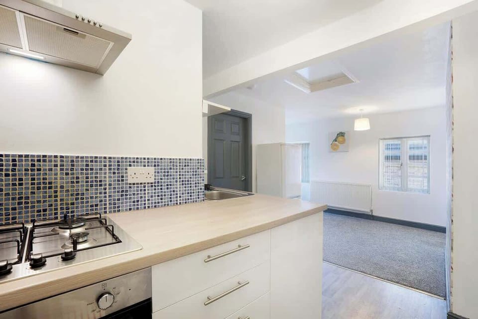 Kitchen equipped with all essentials, including a washer & dryer, oven, fridge and full cookware set.