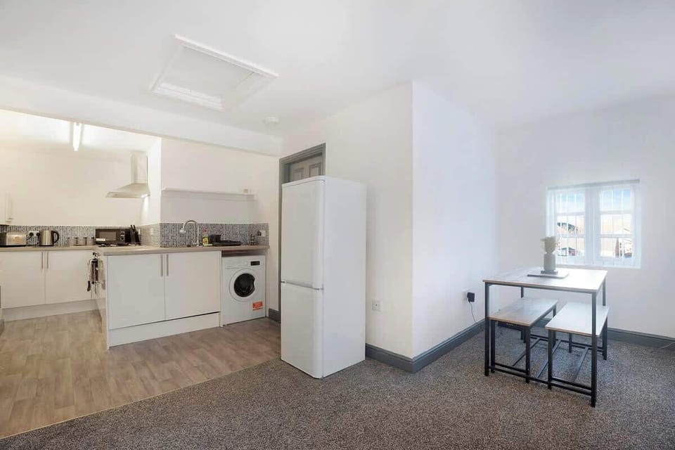 Kitchen equipped with all essentials, including a washer & dryer, oven, fridge and full cookware set.