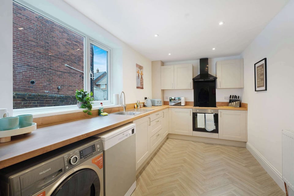 This fully equipped kitchen includes modern appliances, generous preparation space, and a clean open layout suited to everyday cooking. Whether preparing quick breakfasts or full meals, the setup feels practical and easy to use.
