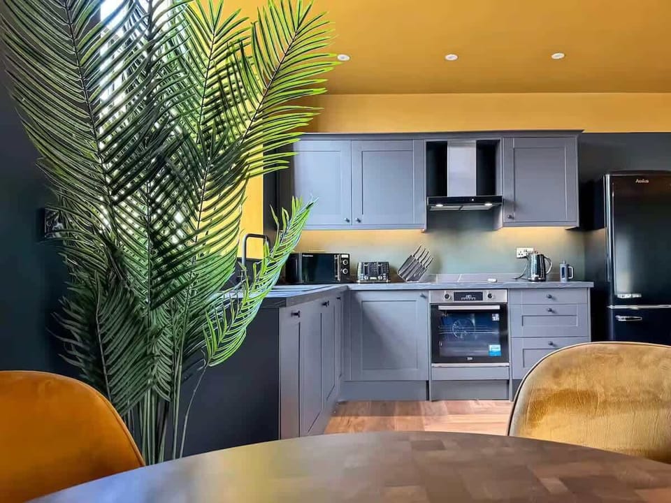 Kitchen equipped with all essentials, including a washer & dryer, oven, fridge and full cookware set.