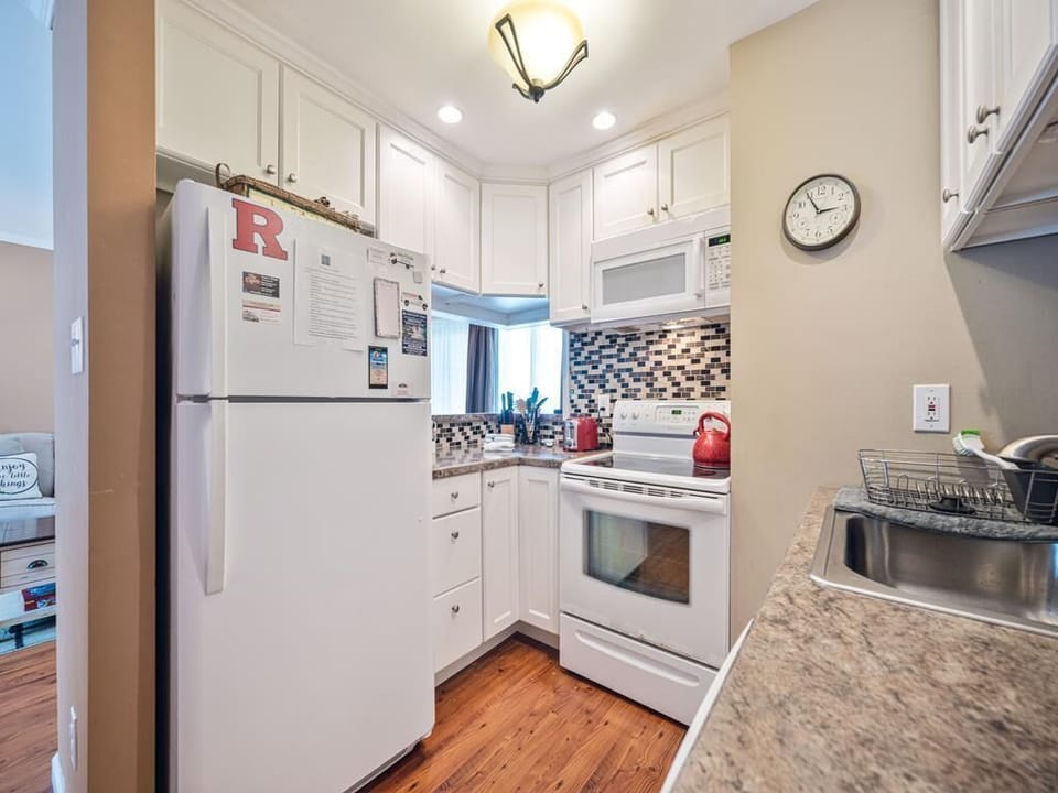 A cozy corner of the kitchen awaits your culinary adventures, complete with beautiful finishes and ample sunlight.