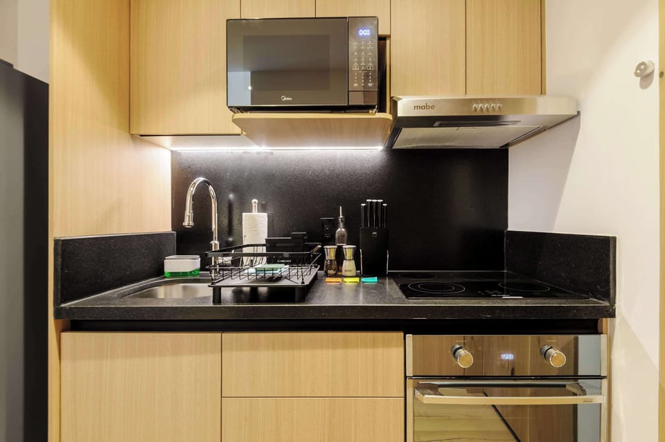 Compact kitchenette perfect for preparing simple meals.
